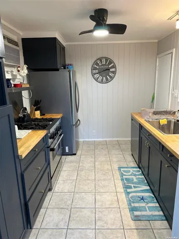 a kitchen with stainless steel appliances a stove a sink and a refrigerator