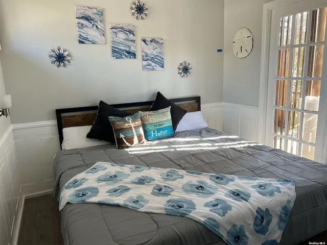 a bedroom with bed and window