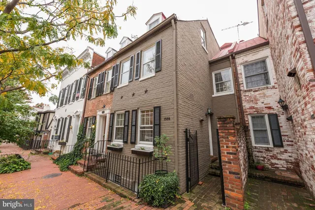 a front view of a house with iron fence
