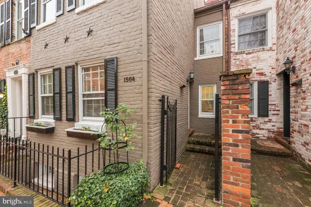 a view of a brick house with large windows