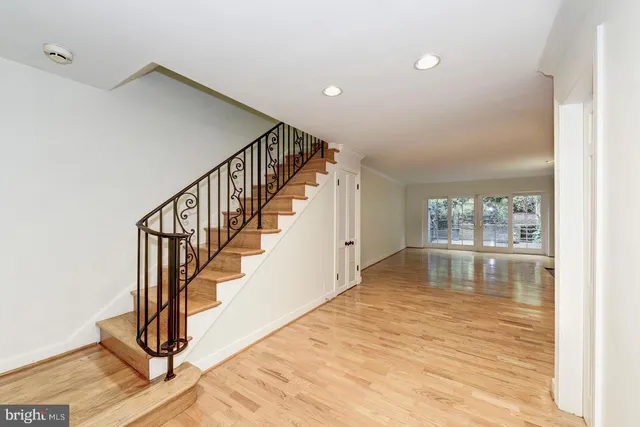a view of entryway and hall with wooden floor