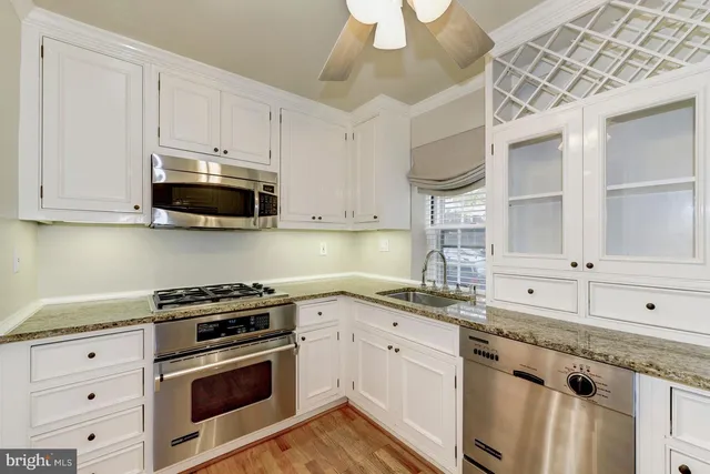 a kitchen with stainless steel appliances granite countertop a sink and a stove