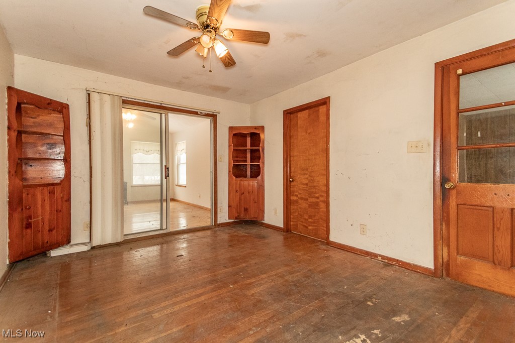 3303 River Road Perry, OH 44081 - Photo 13 of 34 Empty room featuring ceiling fan and dark wood-type flooring