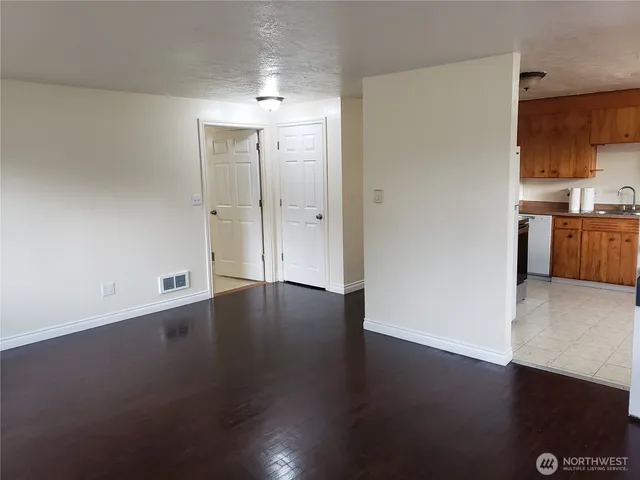 a view of a kitchen with wooden floor and a sink