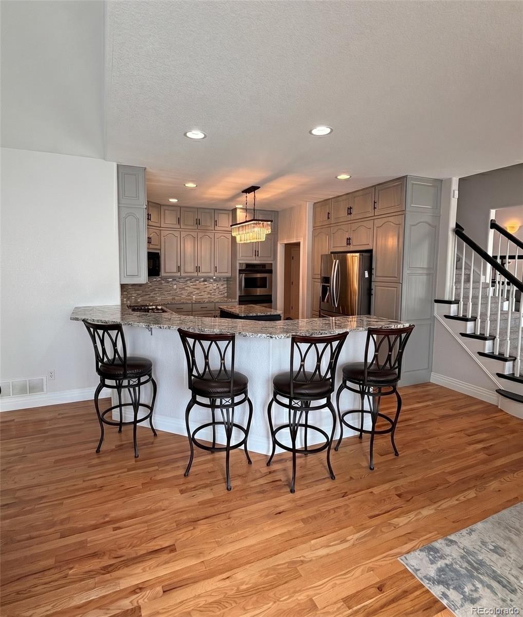 17900 County Road 5 Berthoud, CO 80513 - Photo 12 of 21 a view of a dining area with furniture and wooden floor