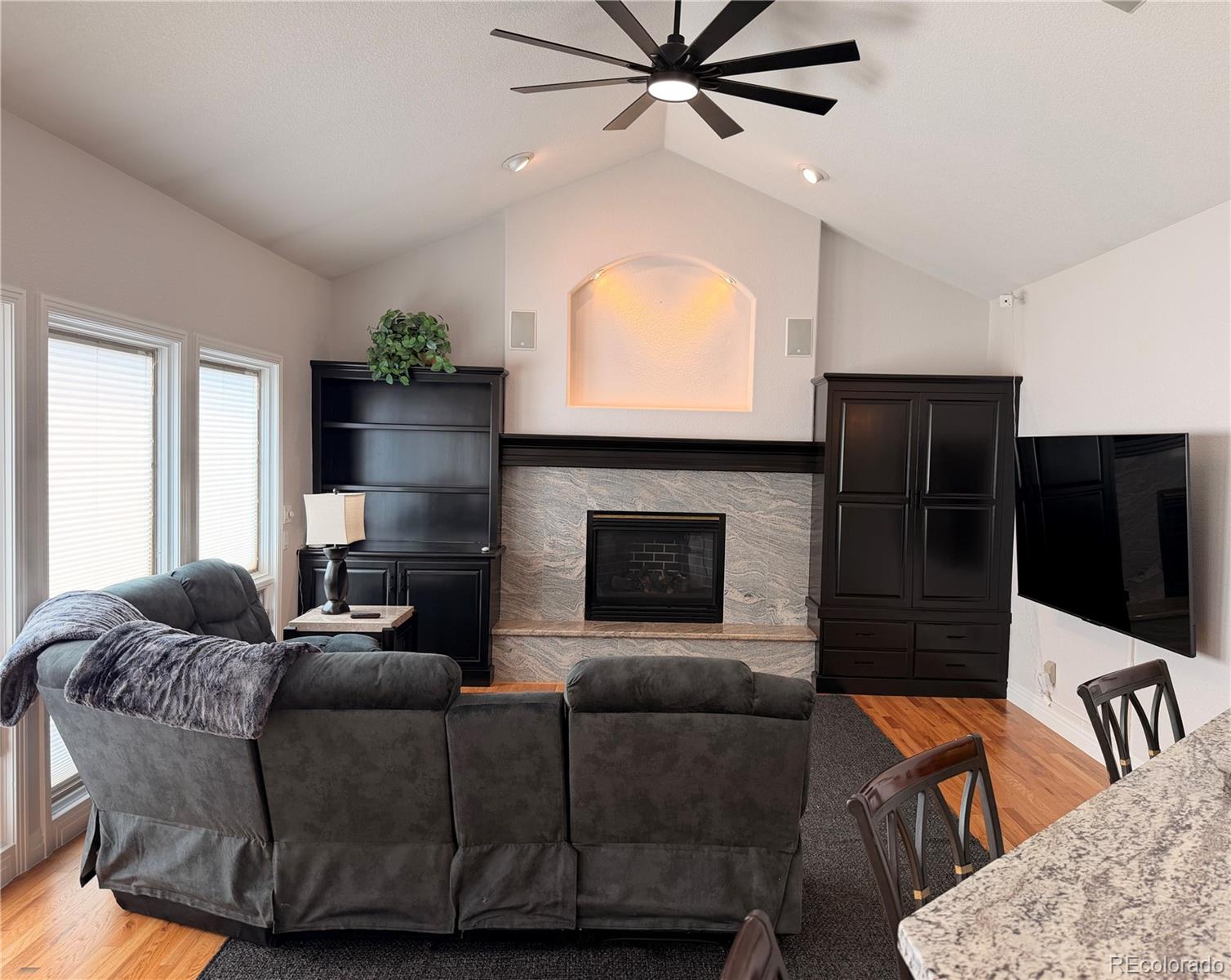 17900 County Road 5 Berthoud, CO 80513 - Photo 13 of 21 a living room with furniture a fireplace and a flat screen tv