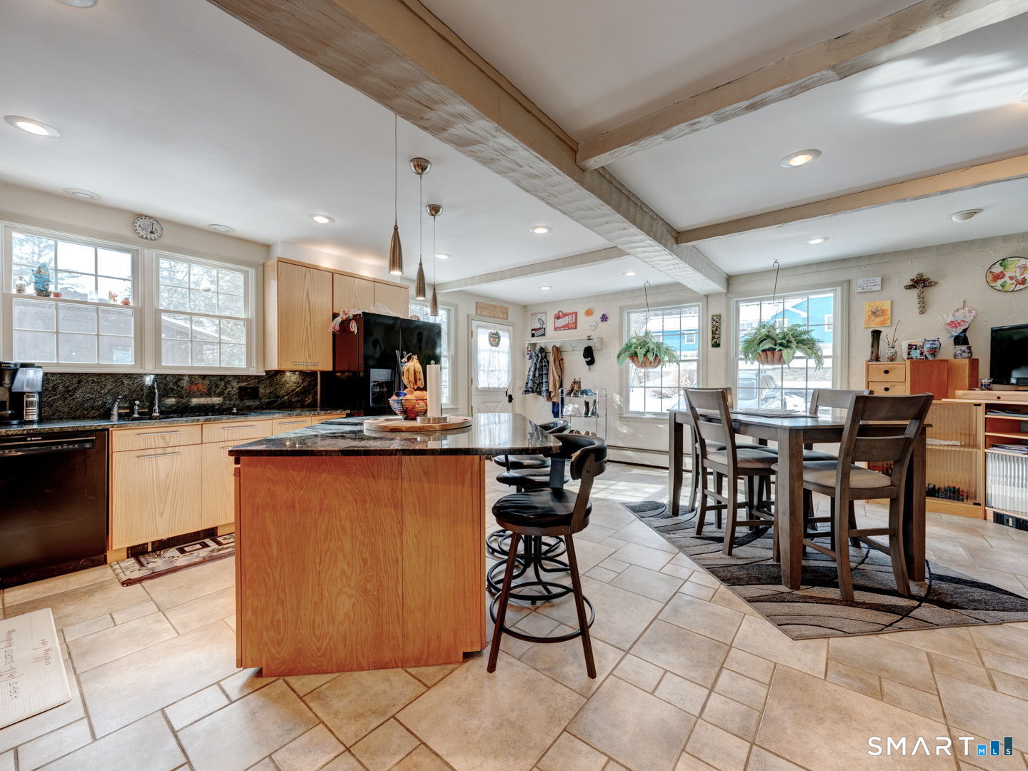 38 Eastwood Road Bristol, CT 06010 - Photo 13 of 40 a kitchen with stainless steel appliances kitchen island granite countertop a table chairs and a refrigerator