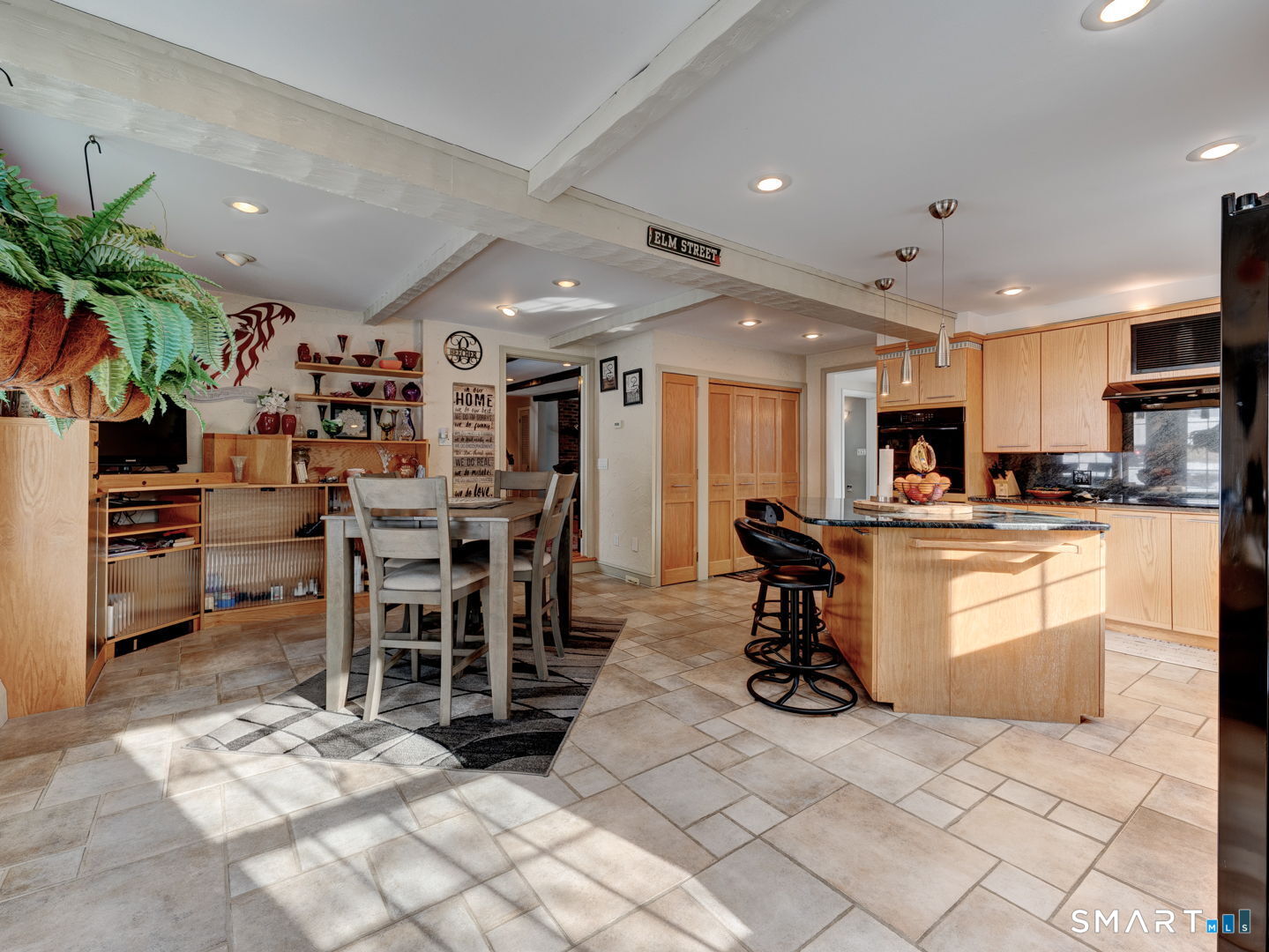 38 Eastwood Road Bristol, CT 06010 - Photo 14 of 40 a kitchen with stainless steel appliances kitchen island granite countertop a refrigerator a stove a sink a dining table and chairs with white cabinets