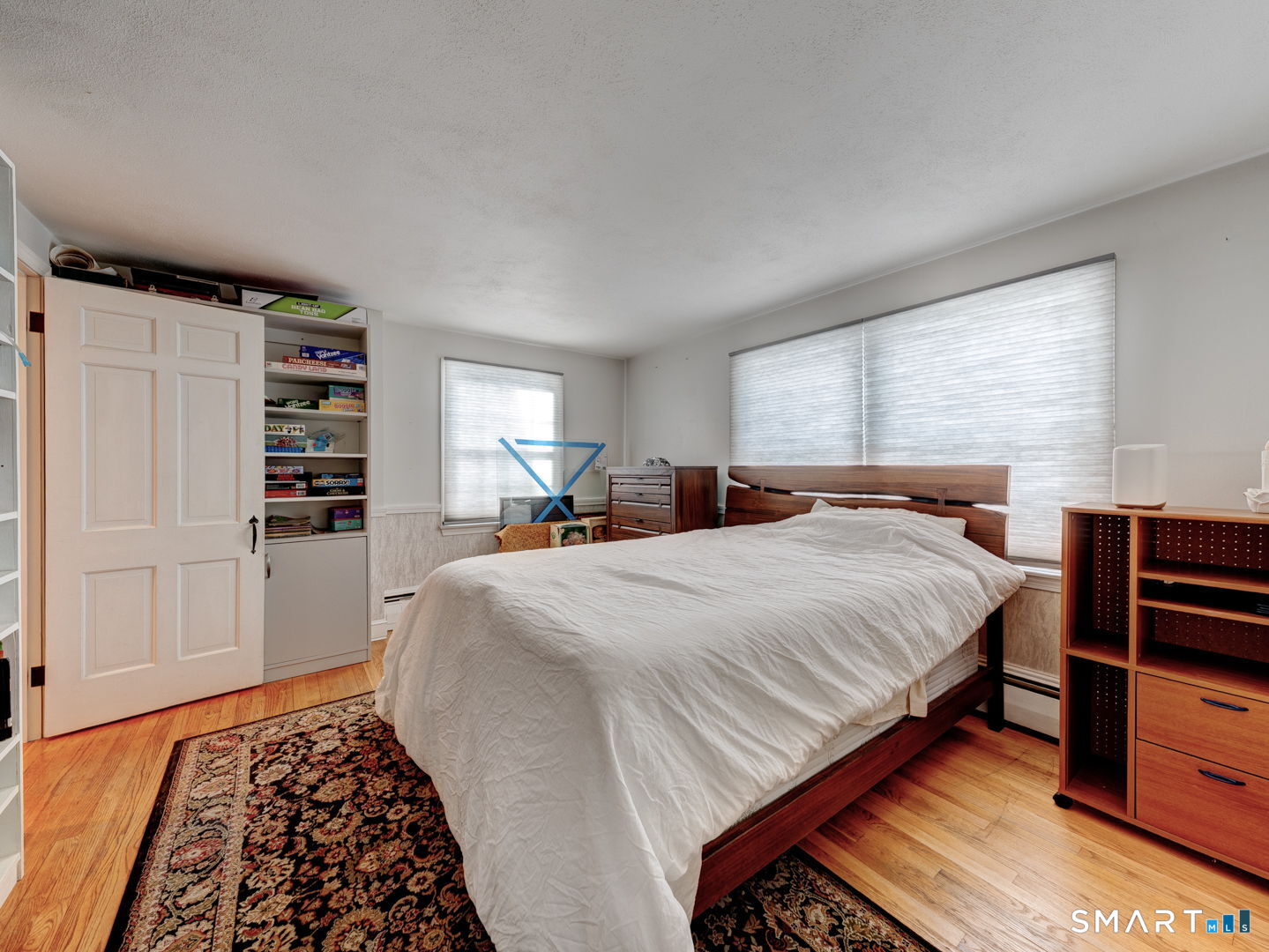 38 Eastwood Road Bristol, CT 06010 - Photo 21 of 40 a bedroom with a large bed and a wooden floor