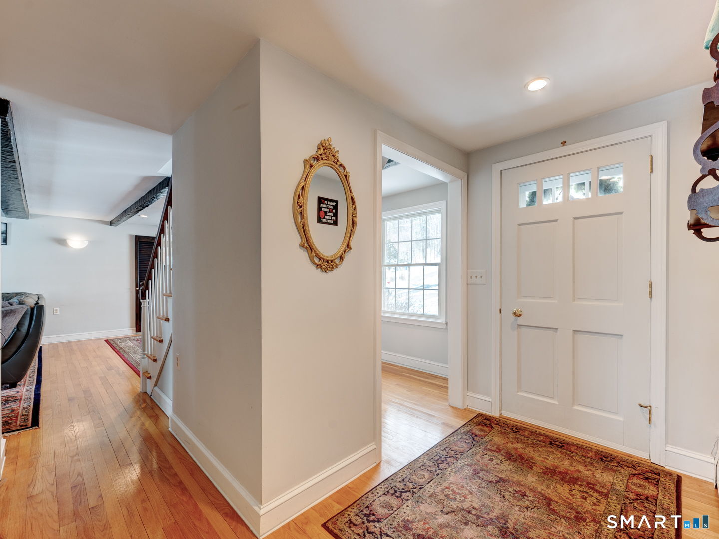 38 Eastwood Road Bristol, CT 06010 - Photo 5 of 40 a view of a hallway with entryway wooden floor and front door