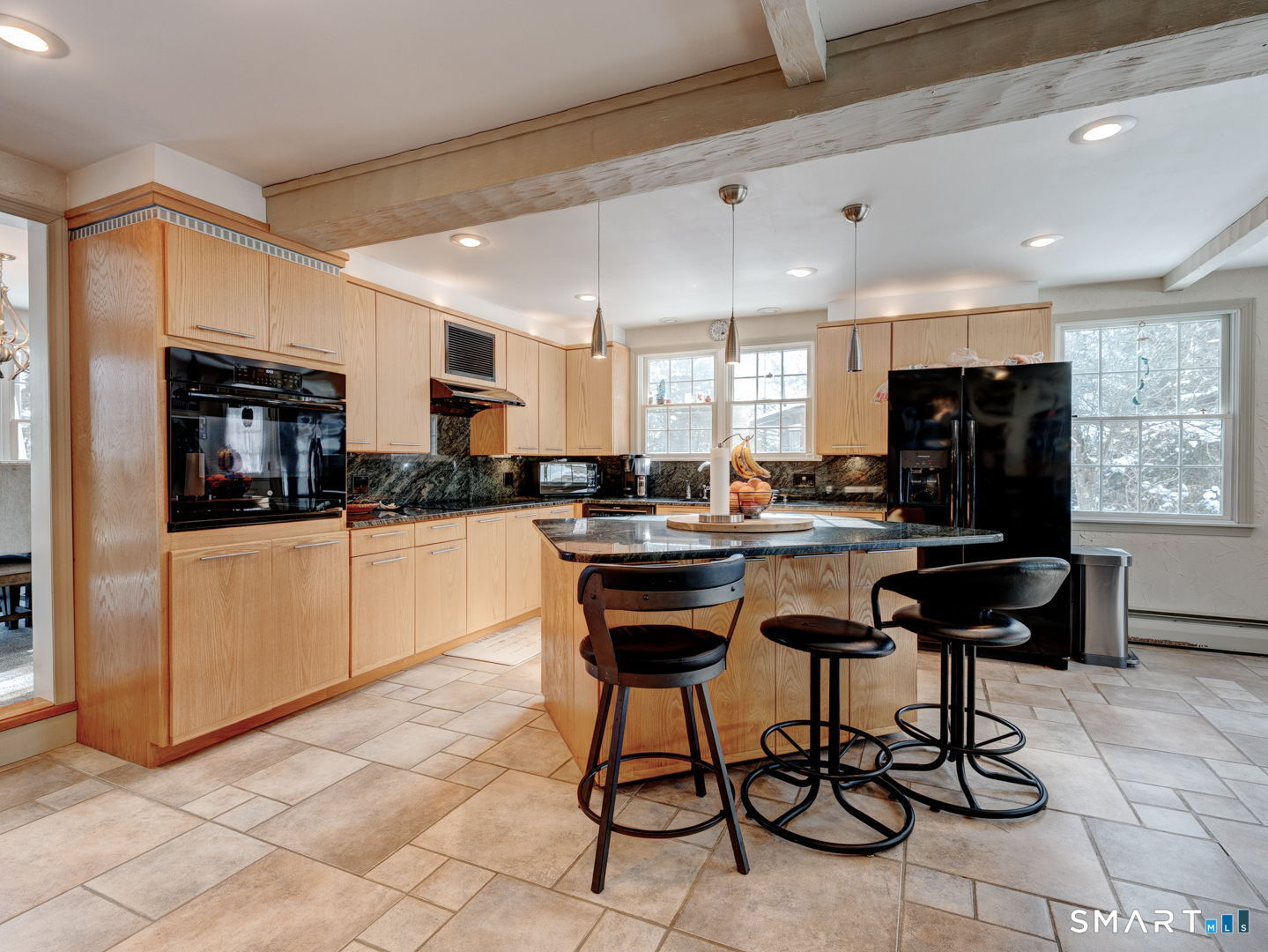 38 Eastwood Road Bristol, CT 06010 - Photo 9 of 40 a kitchen with stainless steel appliances kitchen island granite countertop a refrigerator a stove a sink and white cabinets with wooden floor