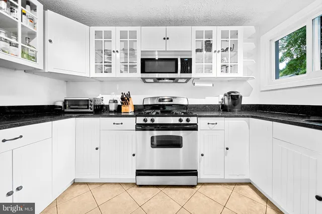 a kitchen with stainless steel appliances granite countertop white refrigerator stove a sink and dishwasher