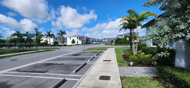 a view of a yard with cars parked