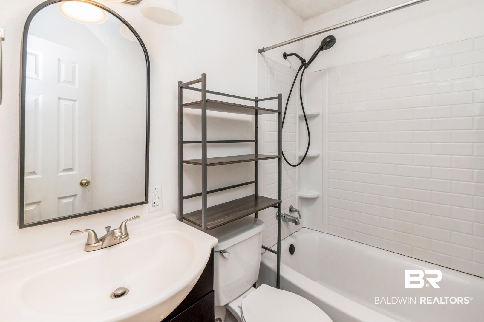 2905A McFarland Road, Unit F Mobile, AL 36695 - Photo 16 of 29 Bathroom featuring a white subway tile shower surround, a built-in bathtub, and a vanity with an integrated sink