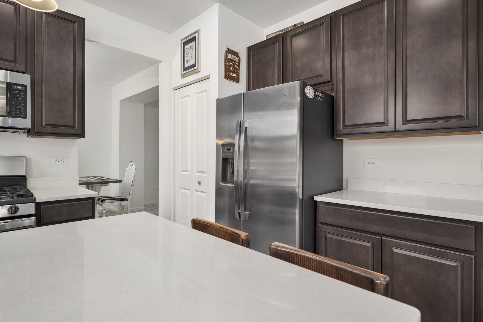 704 Long Ridge Trail Minooka, IL 60447 - Photo 11 of 33 a kitchen with stainless steel appliances wooden cabinets and a refrigerator