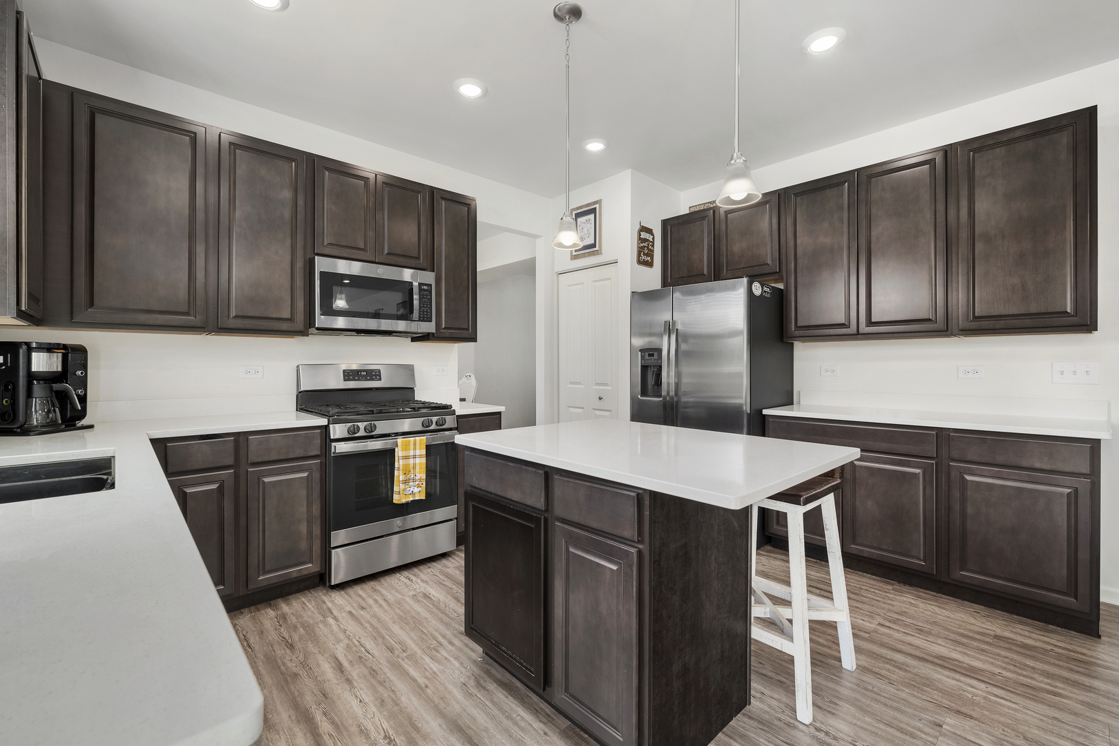 704 Long Ridge Trail Minooka, IL 60447 - Photo 13 of 33 a kitchen with kitchen island granite countertop wooden cabinets and stainless steel appliances