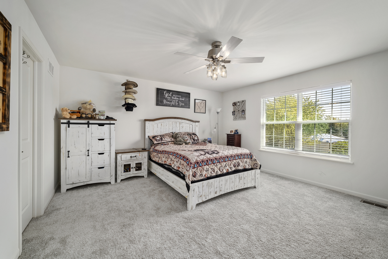 704 Long Ridge Trail Minooka, IL 60447 - Photo 20 of 33 a spacious bedroom with a large bed and a chandelier