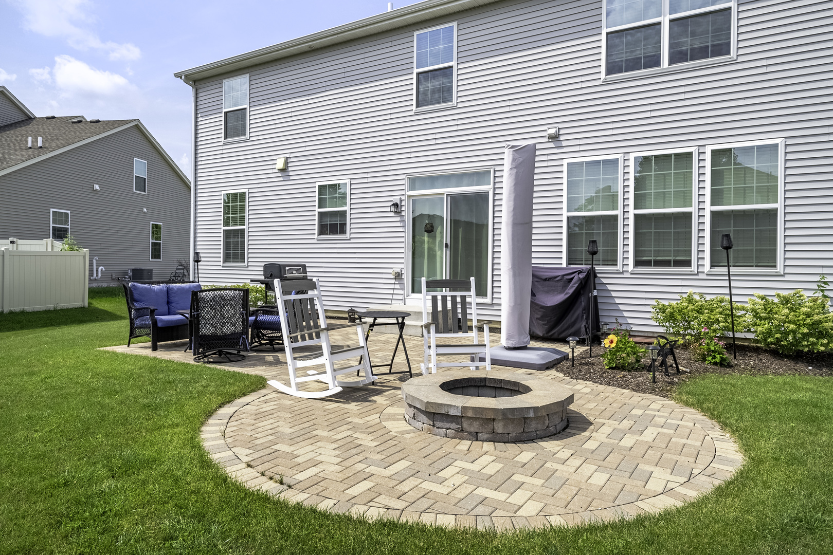 704 Long Ridge Trail Minooka, IL 60447 - Photo 27 of 33 a view of a house with backyard porch and sitting area