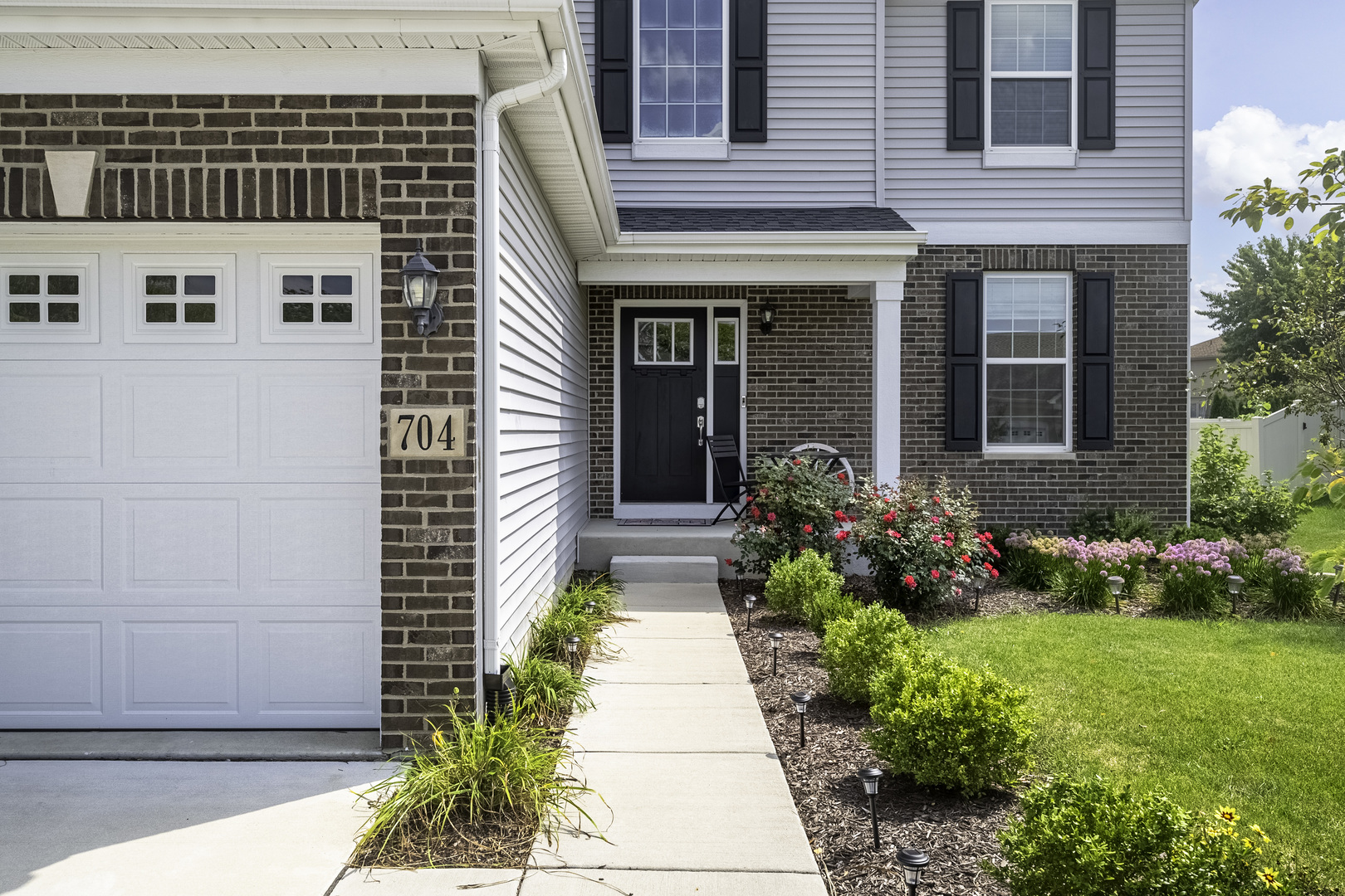 704 Long Ridge Trail Minooka, IL 60447 - Photo 3 of 33 a view of a pathway with flower pots