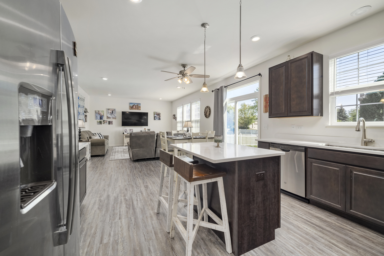 704 Long Ridge Trail Minooka, IL 60447 - Photo 8 of 33 a kitchen with stainless steel appliances kitchen island granite countertop a sink stove and refrigerator