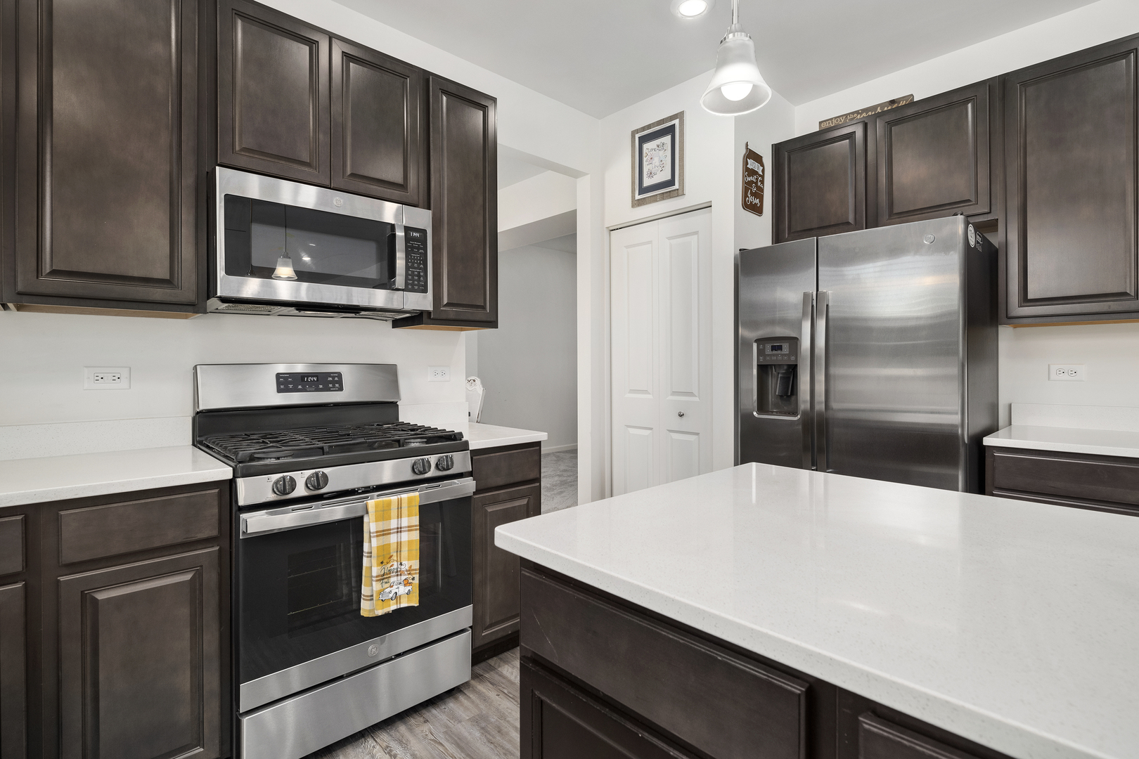 704 Long Ridge Trail Minooka, IL 60447 - Photo 10 of 33 a kitchen with a stove microwave and refrigerator