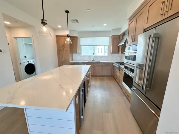 a kitchen with refrigerator and window
