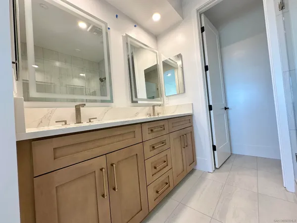 a bathroom with a granite countertop sink mirror and double