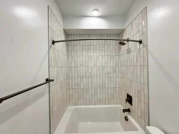 a bathroom with a bathtub and a shower