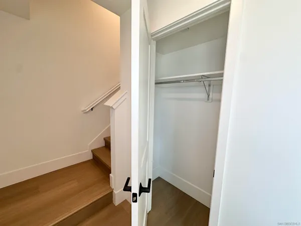 a view of walk in closet with empty racks