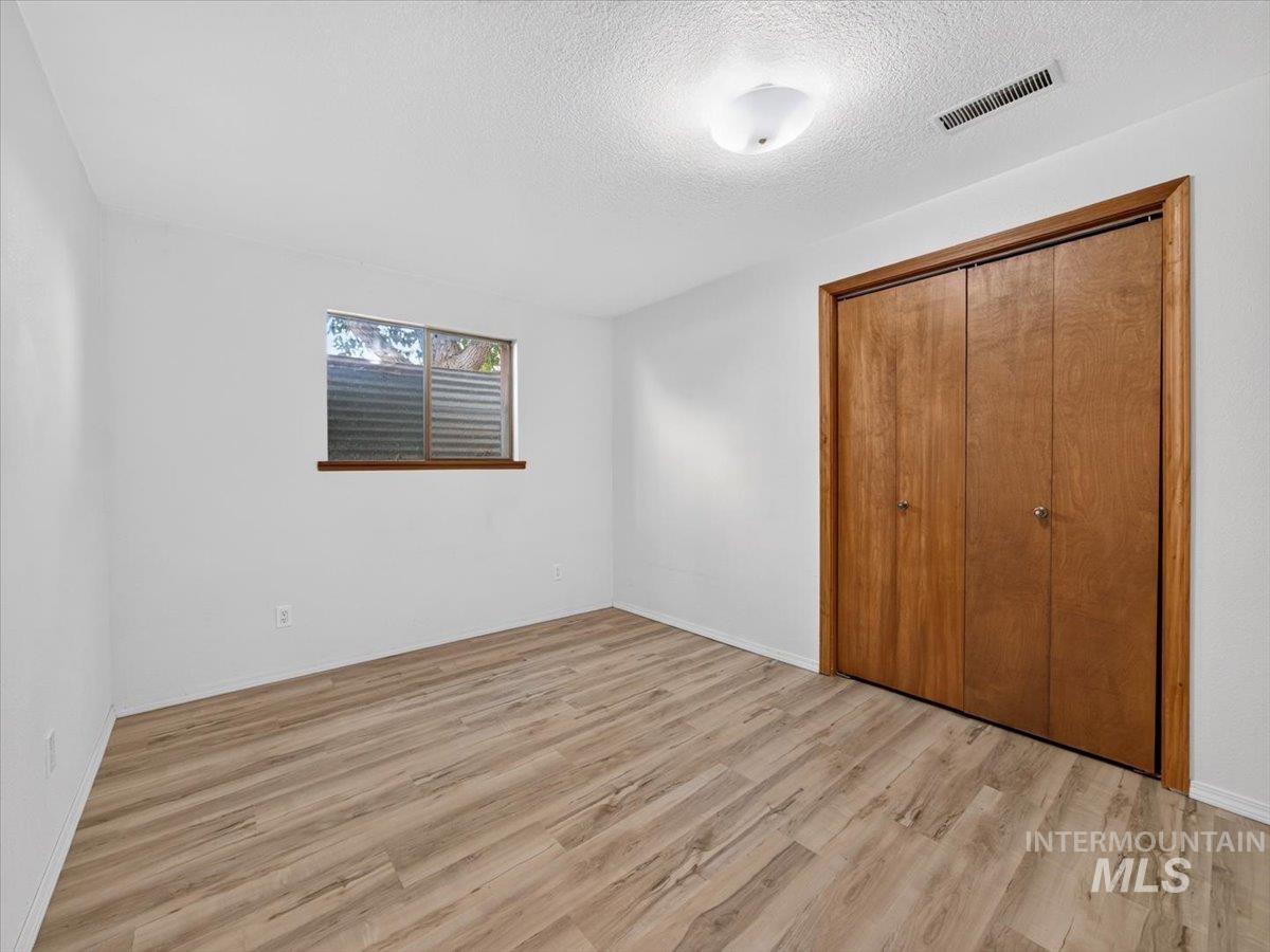 8989 Hillview Road Emmett, ID 83617 - Photo 41 of 50 Room featuring wood-finish flooring, white walls, and a window with a wood-trimmed sill