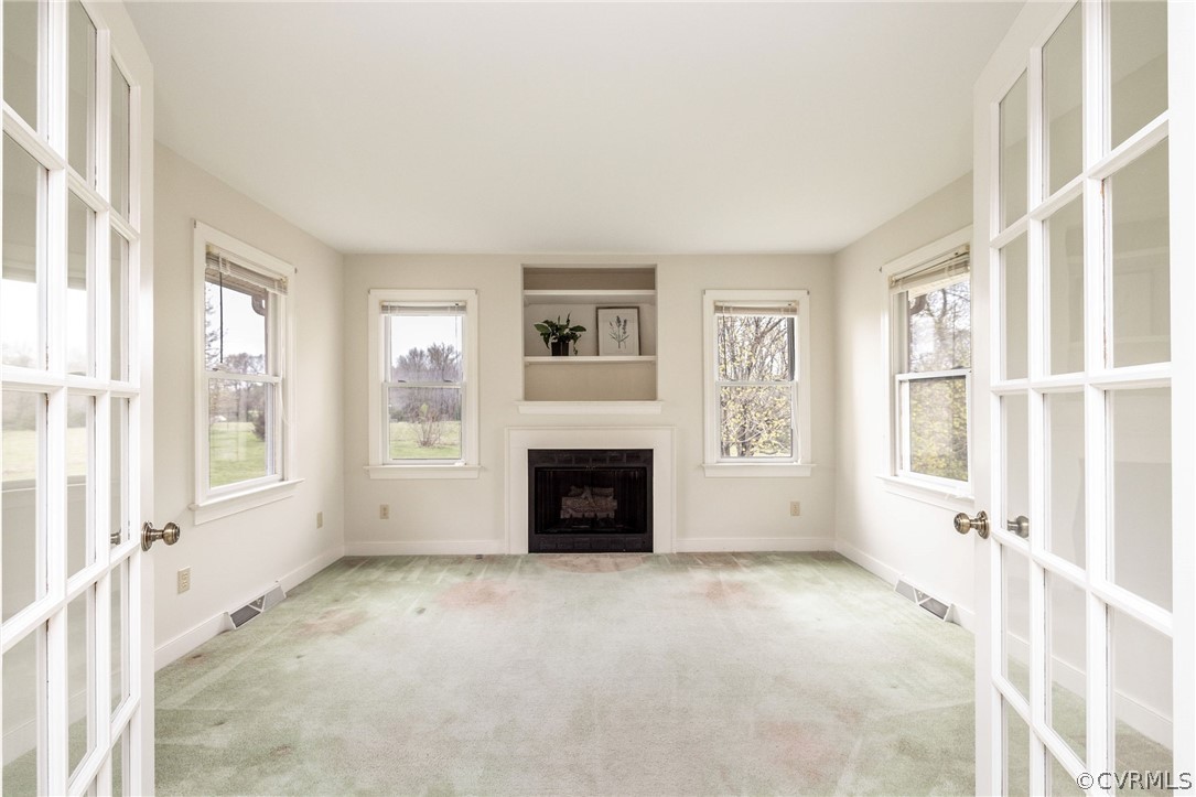 16004 Parsons Road Beaverdam, VA 23015 - Photo 12 of 47 a view of a livingroom with a fireplace window and brick walls