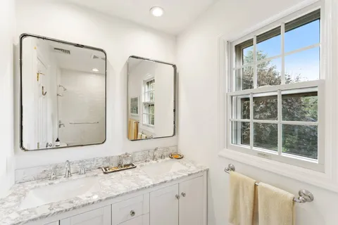 a bathroom with a granite countertop sink mirror and a