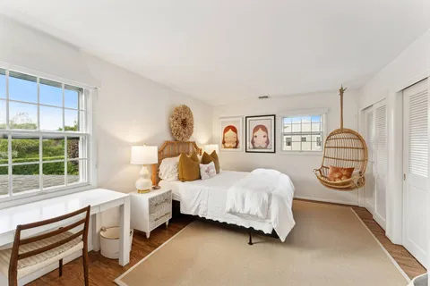 a bedroom with a bed and a window with outer view