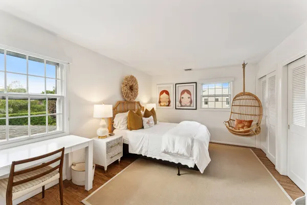 a bedroom with a bed and a window with outer view