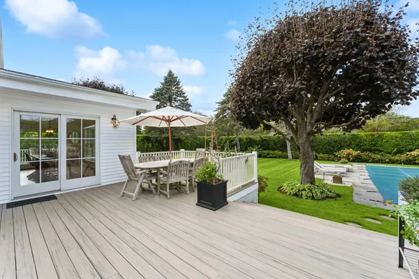 a view of a patio with couches potted plants and a big yard