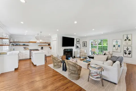 a living room with fireplace furniture and a flat screen tv