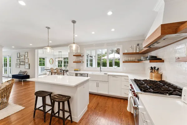 a kitchen with sink stove and chairs