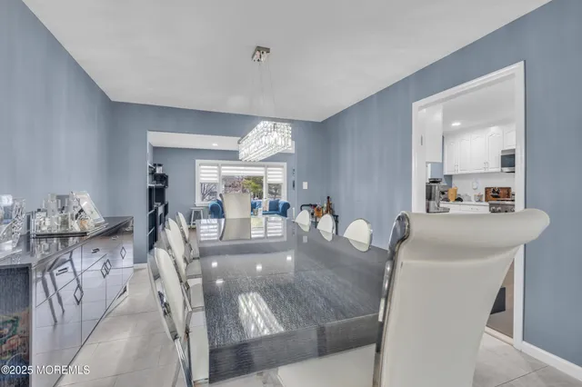 a dining room with furniture and a chandelier