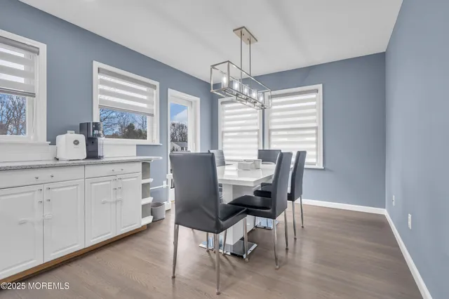 a dining room that has a dining table and chairs in it