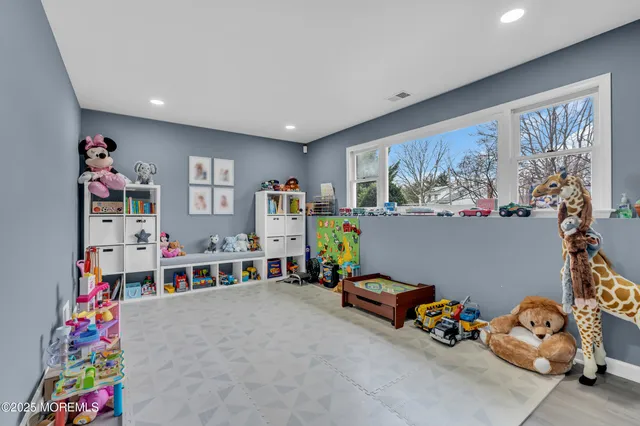 a living room with lots of baby toys and a couch