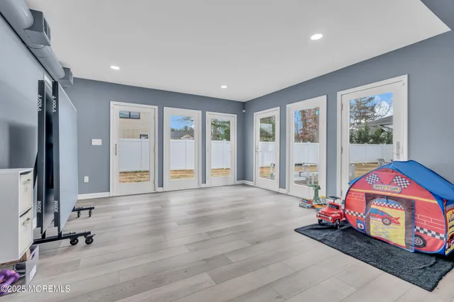 a view of an entryway with wooden floor and windows