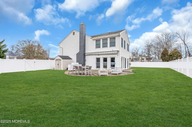 a house view with swimming pool and garden space