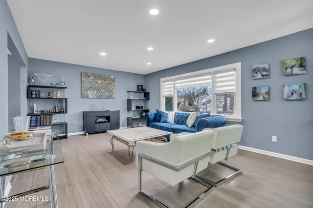 a living room with fireplace furniture and a wooden floor