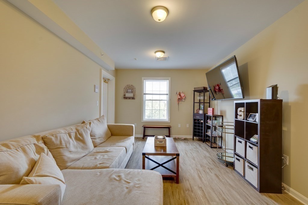 36 Webb Brook Road, Unit 4 Billerica, MA 01821 - Photo 11 of 21 a living room with furniture and a flat screen tv