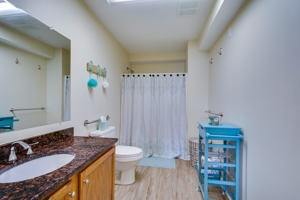 36 Webb Brook Road, Unit 4 Billerica, MA 01821 - Photo 13 of 21 a bathroom with a granite countertop sink and a mirror