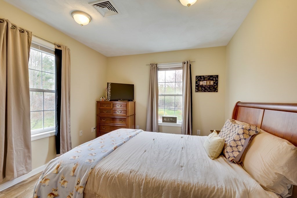 36 Webb Brook Road, Unit 4 Billerica, MA 01821 - Photo 14 of 21 a bedroom with a bed and a flat tv screen next to a window
