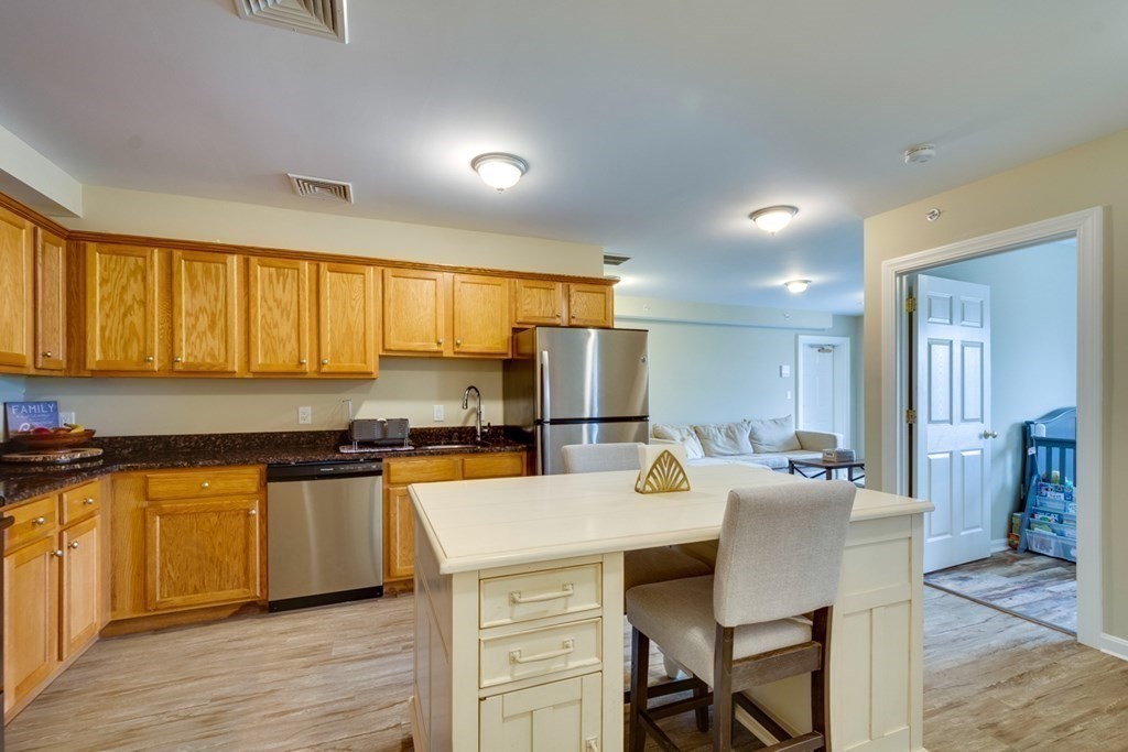 36 Webb Brook Road, Unit 4 Billerica, MA 01821 - Photo 4 of 21 a kitchen with granite countertop a sink counter top space and stainless steel appliances
