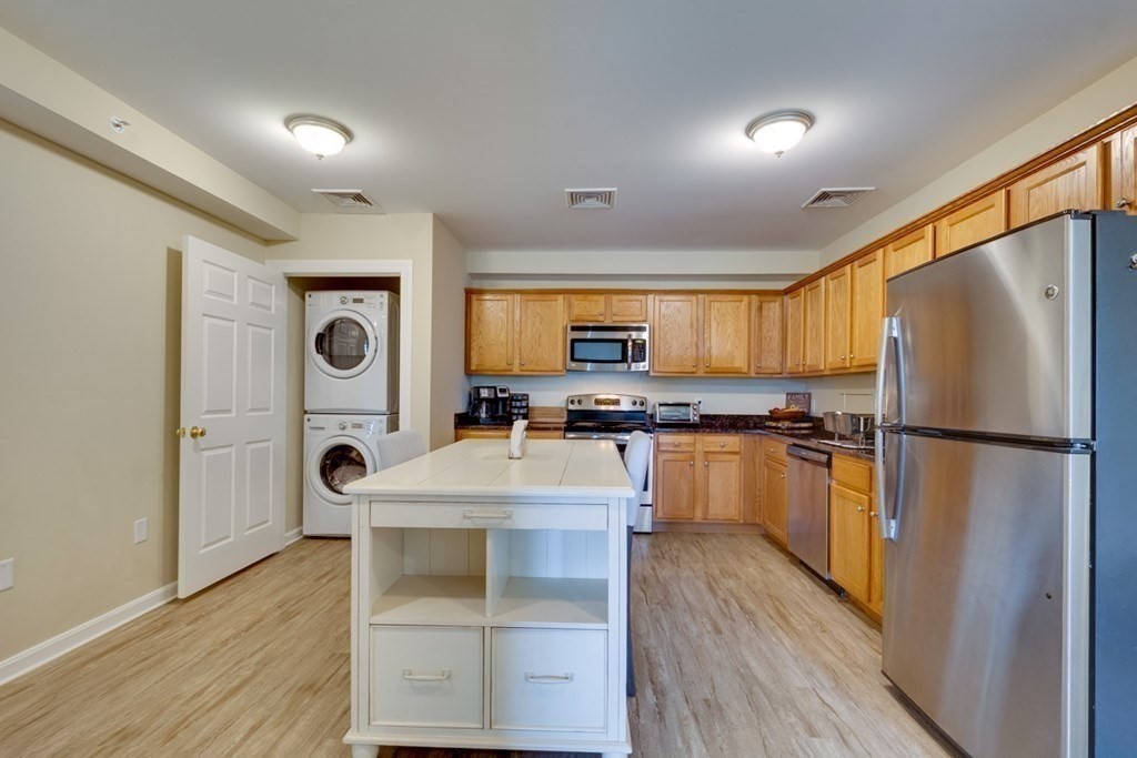 36 Webb Brook Road, Unit 4 Billerica, MA 01821 - Photo 5 of 21 a kitchen with stainless steel appliances a refrigerator and a stove top oven