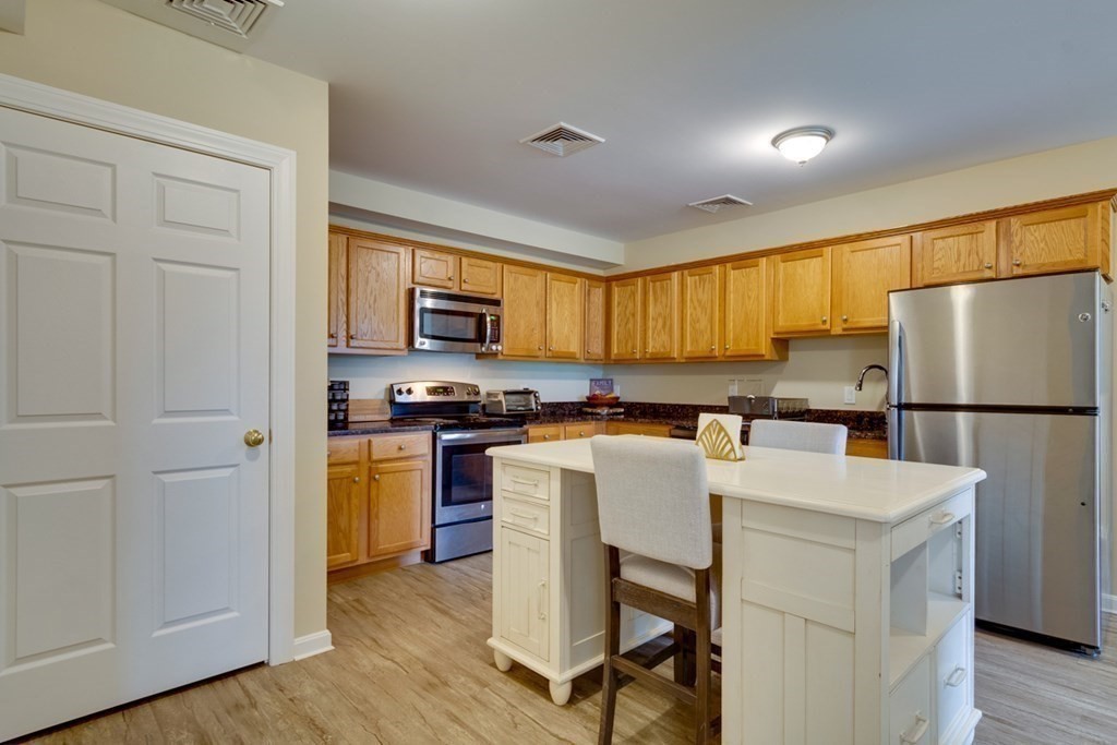 36 Webb Brook Road, Unit 4 Billerica, MA 01821 - Photo 6 of 21 a kitchen with stainless steel appliances granite countertop a refrigerator stove microwave and sink