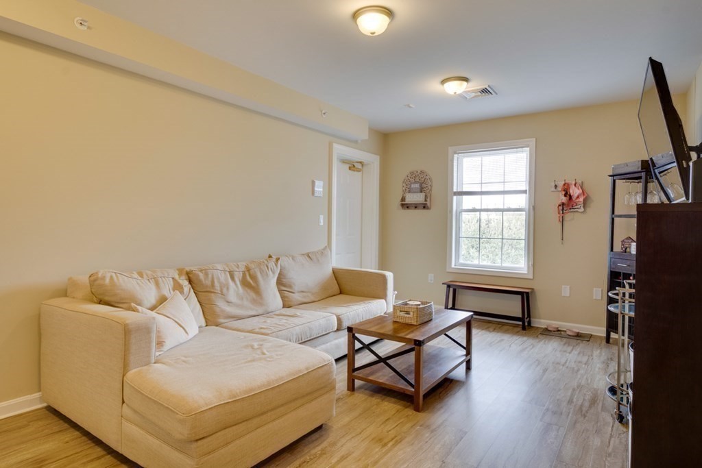 36 Webb Brook Road, Unit 4 Billerica, MA 01821 - Photo 9 of 21 a living room with furniture and a flat screen tv